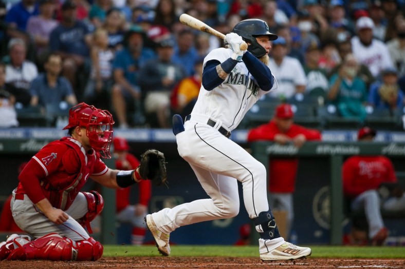 Jul 10, 2021; Seattle, Washington, USA; Seattle Mariners center fielder Jake Fraley (28) hits into a fielders choice to drive in a run against the Los Angeles Angels during the fourth inning at T-Mobile Park. Mandatory Credit: Joe Nicholson-USA TODAY Sports