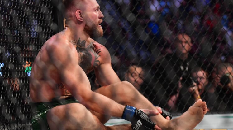 Jul 10, 2021; Las Vegas, Nevada, USA; Conor McGregor holds his leg after suffering an injury against Dustin Poirier during UFC 264 at T-Mobile Arena. Mandatory Credit: Gary A. Vasquez-USA TODAY Sports