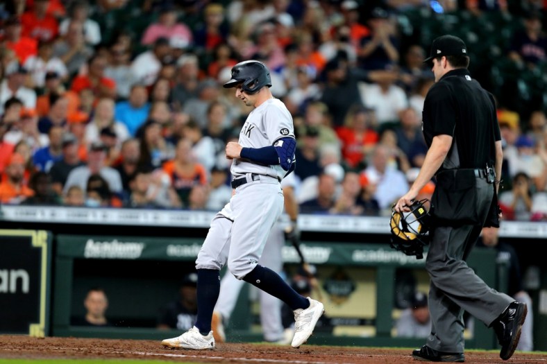 Jul 11, 2021; Houston, Texas, USA; New York Yankees left fielder Tim Locastro (33) crosses home plate after hitting a home run against the Houston Astros during the fourth inning at Minute Maid Park. Mandatory Credit: Erik Williams-USA TODAY Sports