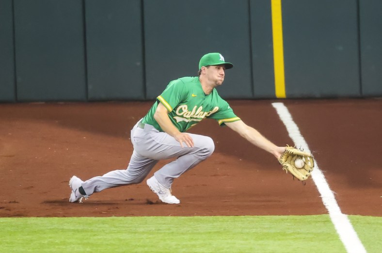 Jul 11, 2021; Arlington, Texas, USA; Oakland Athletics right fielder Stephen Piscotty (25) makes a diving catch during the sixth inning against the Texas Rangers at Globe Life Field. Mandatory Credit: Kevin Jairaj-USA TODAY Sports