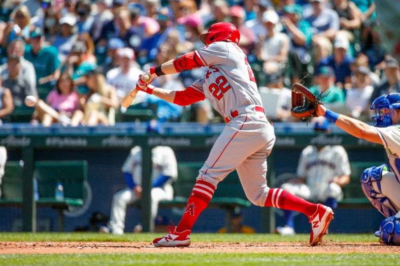 Jul 11, 2021; Seattle, Washington, USA; Los Angeles Angels second baseman David Fletcher (22) hits a two-run RBI single against the Seattle Mariners during the fifth inning at T-Mobile Park. Mandatory Credit: Jennifer Buchanan-USA TODAY Sports