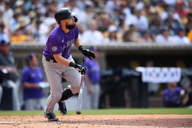 Jul 11, 2021; San Diego, California, USA; Colorado Rockies pinch hitter Chris Owings (12) watches his home run against the San Diego Padres during the seventh inning at Petco Park. Mandatory Credit: Orlando Ramirez-USA TODAY Sports