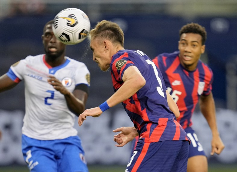 Jul 11, 2021; Kansas City, Kansas, USA; United States defender Sam Vines (3) scores a goal as Haiti defender Carlens Arcus (2) defends in the first half during a CONCACAF Gold Cup group stage soccer match at Children's Mercy Park. Mandatory Credit: Jay Biggerstaff-USA TODAY Sports