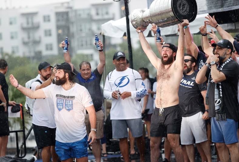 Jul 12, 2021; Tampa, FL, USA;  Tampa Bay Lightning right wing Nikita Kucherov (86) hoists the Stanley Cup during the Stanley Cup Championship parade. Mandatory Credit: Kim Klement-USA TODAY Sports