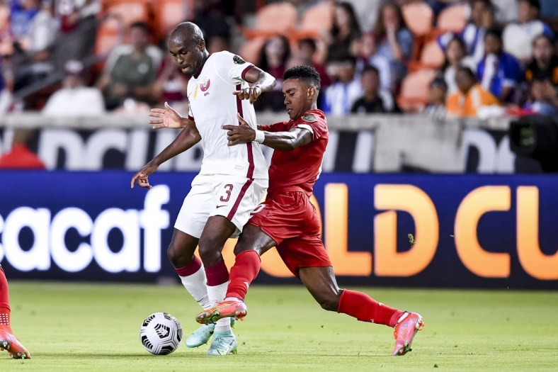 Jul 13, 2021; Houston, Texas, USA; Qatar defender Abdelkarim Hassan (3) and Panama midfielder Edgar Barcenas (10) battle for the ball during the CONCACAF Gold Cup Soccer group stage play at BBVA Stadium. Mandatory Credit: Maria Lysaker-USA TODAY Sports