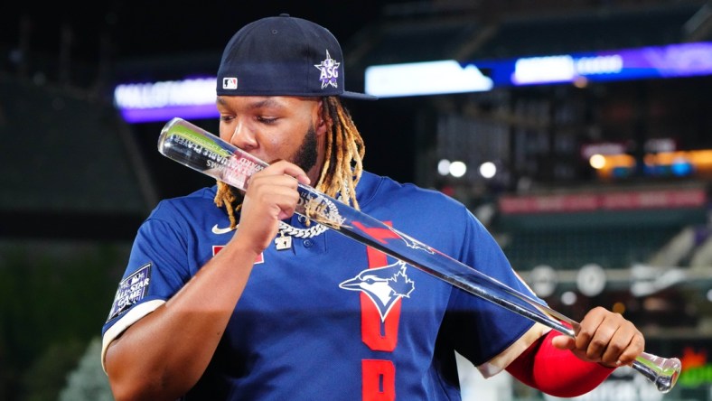 Jul 13, 2021; Denver, Colorado, USA; American League first baseman Vladimir Guerrero Jr. of the Toronto Blue Jays (27) is awarded MVP of the 2021 MLB All Star Game at Coors Field. Mandatory Credit: Mark J. Rebilas-USA TODAY Sports