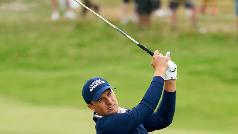 Jul 15, 2021; Sandwich, England, GBR; Jordan Spieth plays his shot from the thirteenth fairway during the first round of the Open Championship golf tournament. Mandatory Credit: Peter van den Berg-USA TODAY Sports