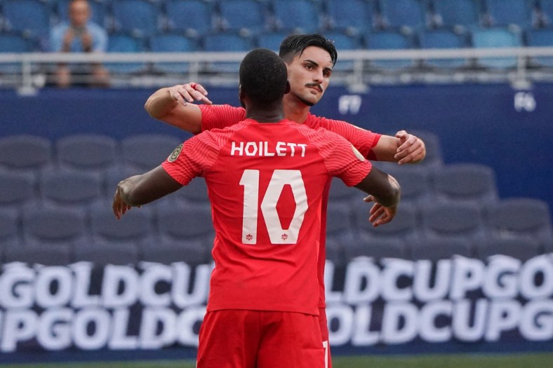 Jul 15, 2021; Kansas City, Kansas, USA; Canada forward Junior Hoilett (10) celebrates with midfielder Stephen Eustaquio (7) after scoring on a penalty kick against h during CONCACAF Gold Cup Soccer group stage play at Children's Mercy Park. Mandatory Credit: Denny Medley-USA TODAY Sports