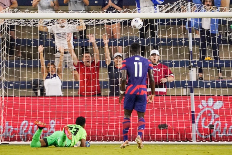 Jul 15, 2021; Kansas City, Kansas, USA; United States forward Daryl Dike (11) scores a goal as Martinique goalkeeper Meslien Gilles (23) looks on during CONCACAF Gold Cup Soccer group stage play at Children's Mercy Park. Mandatory Credit: Denny Medley-USA TODAY Sports