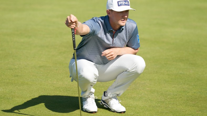 Jul 16, 2021; Sandwich, England, GB; Mackenzie Hughes  lines up a putt on the sixth green during the second  round of the Open Championship golf tournament. Mandatory Credit: Peter van den Berg-USA TODAY Sports