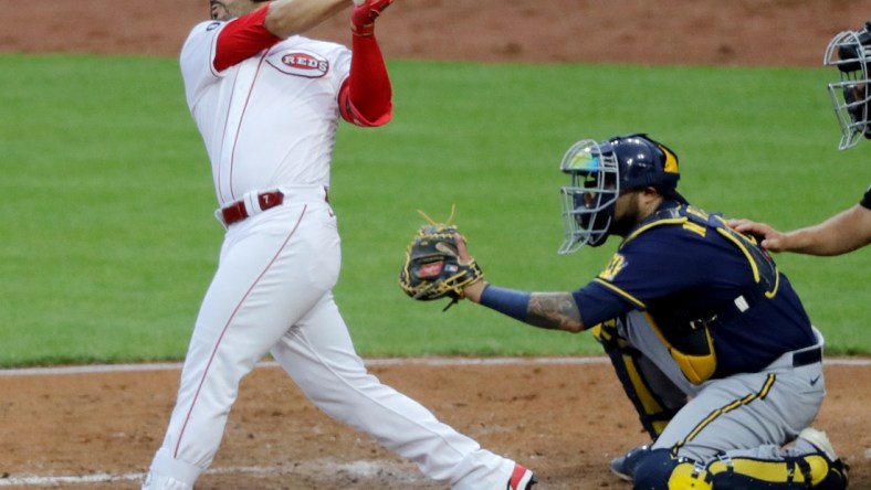 Jul 16, 2021; Cincinnati, Ohio, USA; Cincinnati Reds third baseman Eugenio Suarez (7) hits a two-run double against the Milwaukee Brewers during the third inning at Great American Ball Park. Mandatory Credit: David Kohl-USA TODAY Sports