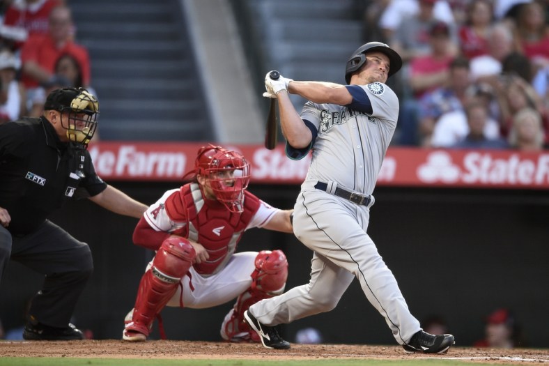 Jul 16, 2021; Anaheim, California, USA; Seattle Mariners third baseman Kyle Seager (15) follows through on a swing for a two-run home run during the third inning against the Los Angeles Angels at Angel Stadium. Mandatory Credit: Kelvin Kuo-USA TODAY Sports