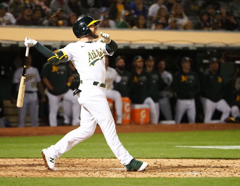 Jul 16, 2021; Oakland, California, USA; Oakland Athletics second baseman Jed Lowrie (8) hits a two run home run for a walk-off win against the Cleveland Indians during the ninth inning at RingCentral Coliseum. Mandatory Credit: Kelley L Cox-USA TODAY Sports