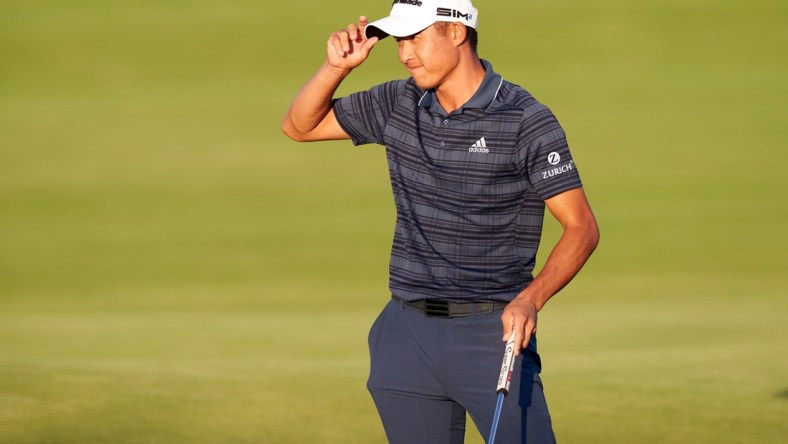 Jul 17, 2021; Sandwich, England, GBR; Collin Morikawa tips his hat after putting out on the 18th green during the third round of the Open Championship golf tournament. Mandatory Credit: Peter van den Berg-USA TODAY Sports