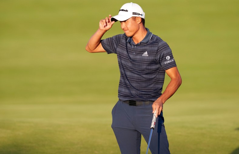Jul 17, 2021; Sandwich, England, GBR; Collin Morikawa tips his hat after putting out on the 18th green during the third round of the Open Championship golf tournament. Mandatory Credit: Peter van den Berg-USA TODAY Sports