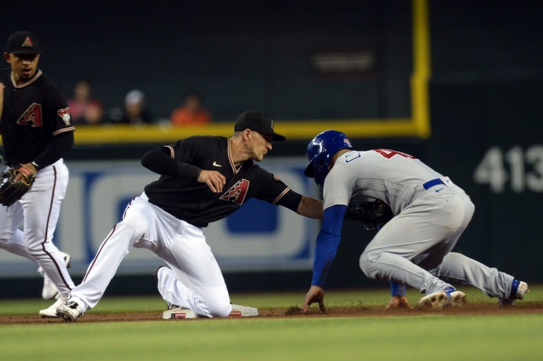 Jul 17, 2021; Phoenix, Arizona, USA; Arizona Diamondbacks shortstop Nick Ahmed (13) tags out Chicago Cubs catcher Willson Contreras (40) during a steal attempt during the third inning at Chase Field. Mandatory Credit: Joe Camporeale-USA TODAY Sports