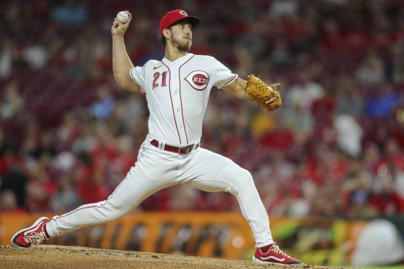 Jul 17, 2021; Cincinnati, Ohio, USA; Cincinnati Reds relief pitcher Michael Lorenzen (21) throws a pitch against the Milwaukee Brewers in the eighth inning at Great American Ball Park. Mandatory Credit: Katie Stratman-USA TODAY Sports