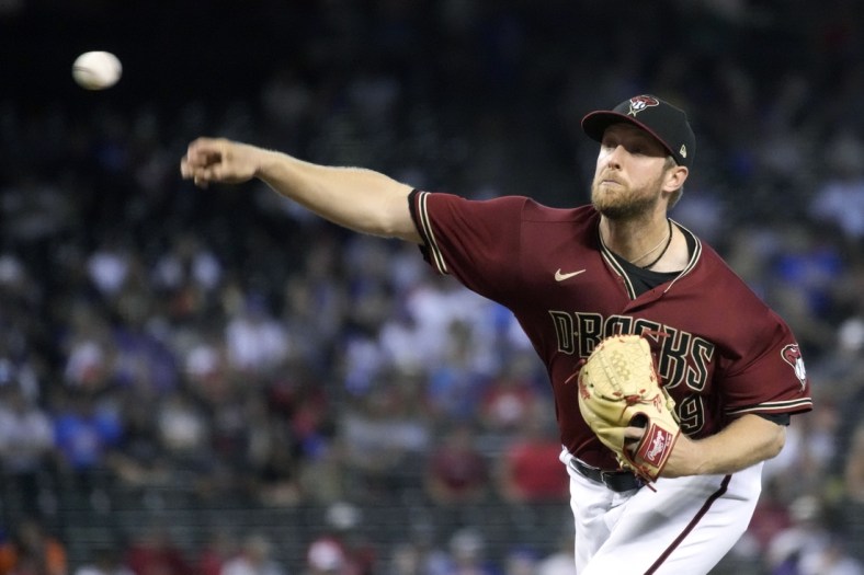 Jul 18, 2021; Phoenix, Arizona, USA; Arizona Diamondbacks starting pitcher Merrill Kelly (29) throws a pitch against the Chicago Cubs in the first inning at Chase Field. Mandatory Credit: Rick Scuteri-USA TODAY Sports