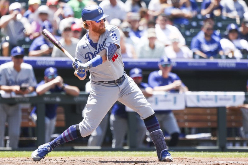 Jul 18, 2021; Denver, Colorado, USA; Los Angeles Dodgers third baseman Justin Turner (10) hits a two-run home run against the Colorado Rockies in the third inning at Coors Field. Mandatory Credit: Michael Ciaglo-USA TODAY Sports