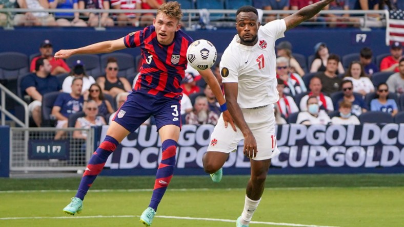 Jul 18, 2021; Kansas City, Kansas, USA; United States defender Sam Vines (3) and Canada forward Cyle Larin (17) battle for the ball during the CONCACAF Gold Cup Soccer group stage play at Children's Mercy Park. Mandatory Credit: Denny Medley-USA TODAY Sports