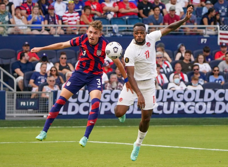 Jul 18, 2021; Kansas City, Kansas, USA; United States defender Sam Vines (3) and Canada forward Cyle Larin (17) battle for the ball during the CONCACAF Gold Cup Soccer group stage play at Children's Mercy Park. Mandatory Credit: Denny Medley-USA TODAY Sports