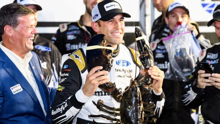 Jul 18, 2021; Loudon, New Hampshire, USA; NASCAR Cup Series driver Aric Almirola (10) holds up a lobster after winning the Foxwoods Resort Casino 301 at the New Hampshire Motor Speedway. Mandatory Credit: Brian Fluharty-USA TODAY Sports