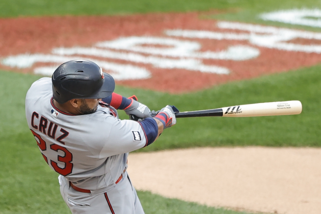 Jul 19, 2021; Chicago, Illinois, USA; Minnesota Twins designated hitter Nelson Cruz (23) hits a solo home run against the Chicago White Sox during the sixth inning of a Game 1 of the doubleheader at Guaranteed Rate Field. Mandatory Credit: Kamil Krzaczynski-USA TODAY Sports