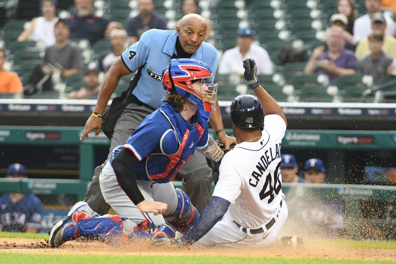 Jul 19, 2021; Detroit, Michigan, USA; Texas Rangers catcher Jonah Heim (28) tags out Detroit Tigers designated hitter Jeimer Candelario (46) at home during the fourth inning at Comerica Park. Mandatory Credit: Tim Fuller-USA TODAY Sports