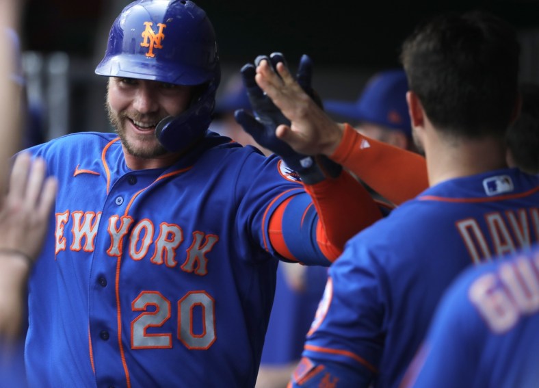 Jul 19, 2021; Cincinnati, Ohio, USA; New York Mets first baseman Pete Alonso (20) celebrates in the dugout after hitting a two-run home run against the Cincinnati Reds during the first inning at Great American Ball Park. Mandatory Credit: David Kohl-USA TODAY Sports