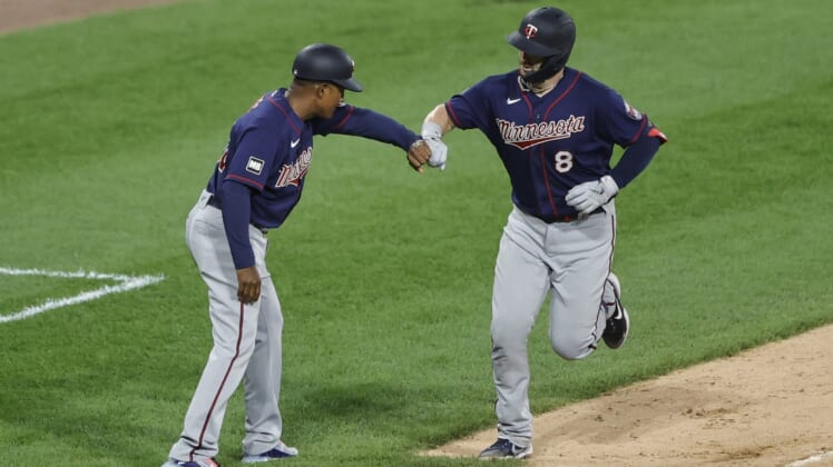 Jul 19, 2021; Chicago, Illinois, USA; Minnesota Twins center fielder Mitch Garver (8) celebrates with third base coach Tony Diaz (46) after hitting a solo home run against the Chicago White Sox during the fifth inning of a Game 2 of the doubleheader at Guaranteed Rate Field. Mandatory Credit: Kamil Krzaczynski-USA TODAY Sports