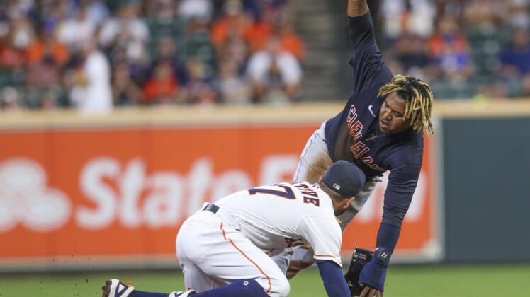 Jul 19, 2021; Houston, Texas, USA; Cleveland Indians third baseman Jose Ramirez (11) steals second base as Houston Astros second baseman Jose Altuve (27) applies the tag in the first inning Minute Maid Park. Mandatory Credit: Thomas Shea-USA TODAY Sports