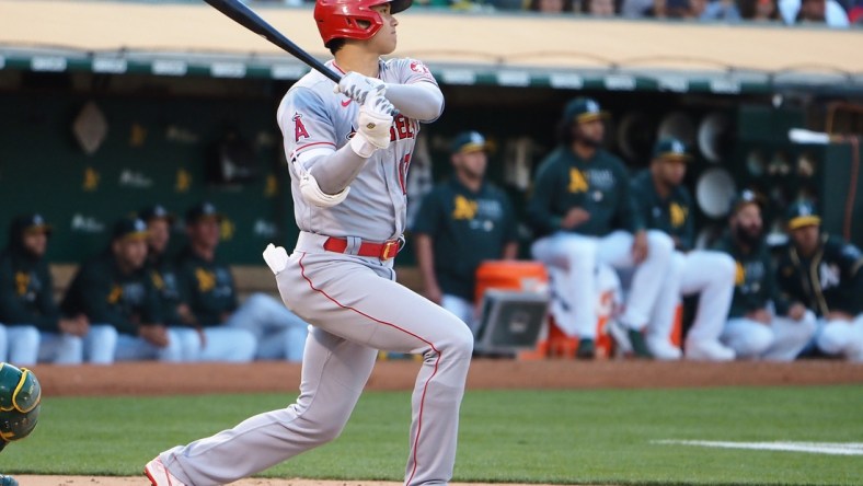 Jul 19, 2021; Oakland, California, USA; Los Angeles Angels designated hitter Shohei Ohtani (17) hits a double against the Oakland Athletics during the third inning at RingCentral Coliseum. Mandatory Credit: Kelley L Cox-USA TODAY Sports