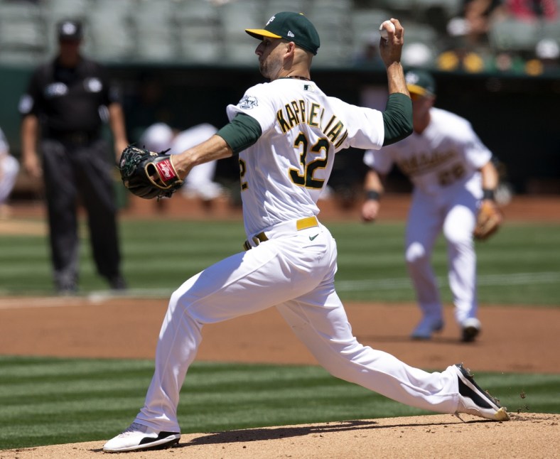 Jul 20, 2021; Oakland, California, USA; Oakland Athletics starting pitcher James Kaprielian (32) delivers against the Los Angeles Angels during the first inning at RingCentral Coliseum. Mandatory Credit: D. Ross Cameron-USA TODAY Sports