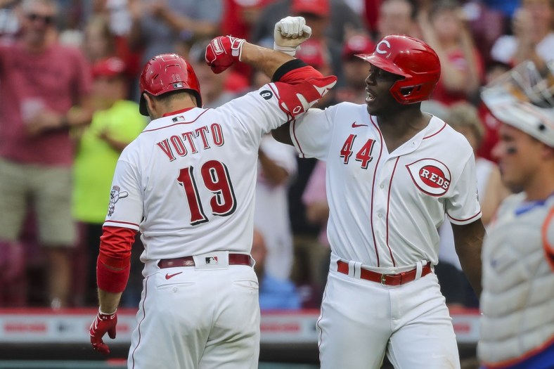 Jul 20, 2021; Cincinnati, Ohio, USA; Cincinnati Reds first baseman Joey Votto (19) reacts after hitting a solo home run with right fielder Aristides Aquino (44) in the third inning against the New York Mets at Great American Ball Park. Mandatory Credit: Katie Stratman-USA TODAY Sports