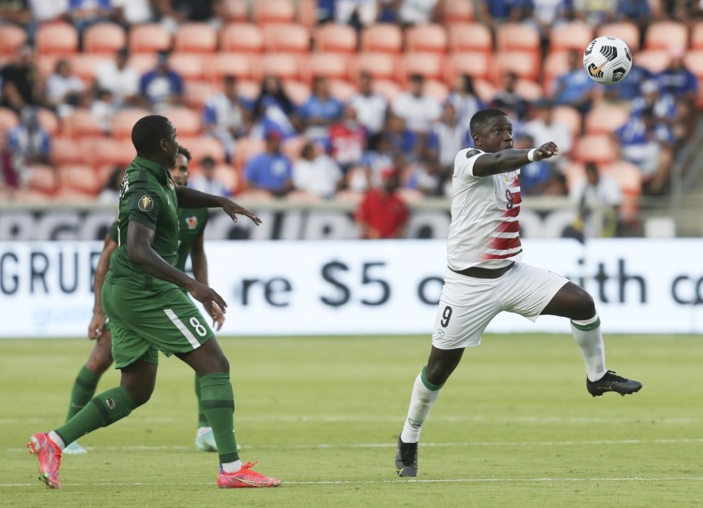 Jul 20, 2021; Houston, Texas, USA; Suriname  forward Nigel Hasselbaink (9) heads the ball against Guadeloupe in the second half during a CONCACAF Gold Cup group stage soccer match at BBVA Stadium. Mandatory Credit: Thomas Shea-USA TODAY Sports