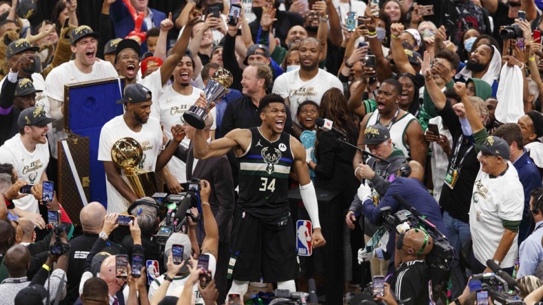 Jul 20, 2021; Milwaukee, Wisconsin, USA; Milwaukee Bucks forward Giannis Antetokounmpo (34) celebrates with the NBA Finals MVP Trophy following the game against the Phoenix Suns following game six of the 2021 NBA Finals at Fiserv Forum. Mandatory Credit: Jeff Hanisch-USA TODAY Sports