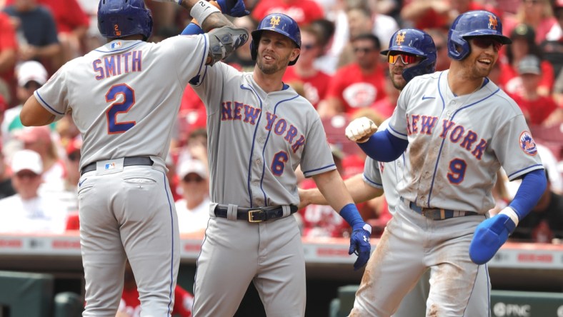 Jul 21, 2021; Cincinnati, Ohio, USA; New York Mets left fielder Dominic Smith (2) celebrates with second baseman Jeff McNeil (6) center fielder Brandon Nimmo (9) and first baseman Pete Alonso (20) after hitting a grand slam home run against the Cincinnati Reds in the third inning at Great American Ball Park. Mandatory Credit: David Kohl-USA TODAY Sports