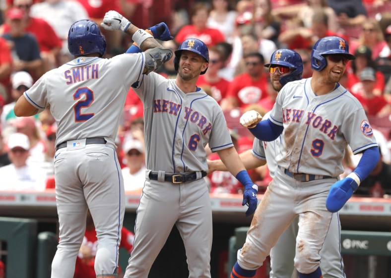 Jul 21, 2021; Cincinnati, Ohio, USA; New York Mets left fielder Dominic Smith (2) celebrates with second baseman Jeff McNeil (6) center fielder Brandon Nimmo (9) and first baseman Pete Alonso (20) after hitting a grand slam home run against the Cincinnati Reds in the third inning at Great American Ball Park. Mandatory Credit: David Kohl-USA TODAY Sports