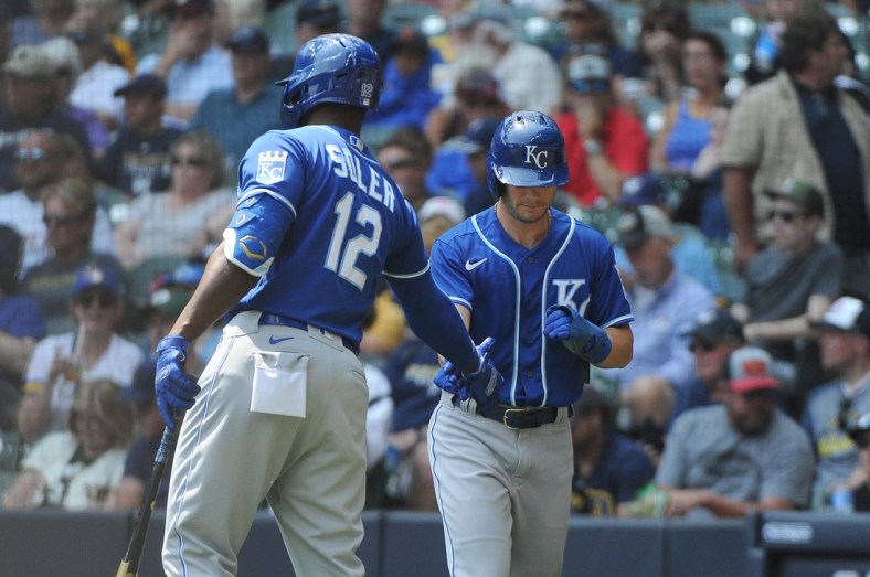 Jul 21, 2021; Milwaukee, Wisconsin, USA; Kansas City Royals right fielder Jorge Soler (12) congratulates left fielder Andrew Benintendi (right) after scoring a run against the Milwaukee Brewers in the fourth inning at American Family Field. Mandatory Credit: Michael McLoone-USA TODAY Sports