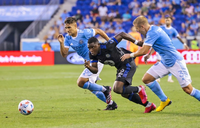 Jul 21, 2021; Harrison, New Jersey, USA;  CF Montreal forward Sunusi Ibrahim (22) battles for the ball with New York City midfielder Nicolas Acevedo (26) and defender Anton Tinnerholm (3) during the first half at Red Bull Arena. Mandatory Credit: Vincent Carchietta-USA TODAY Sports