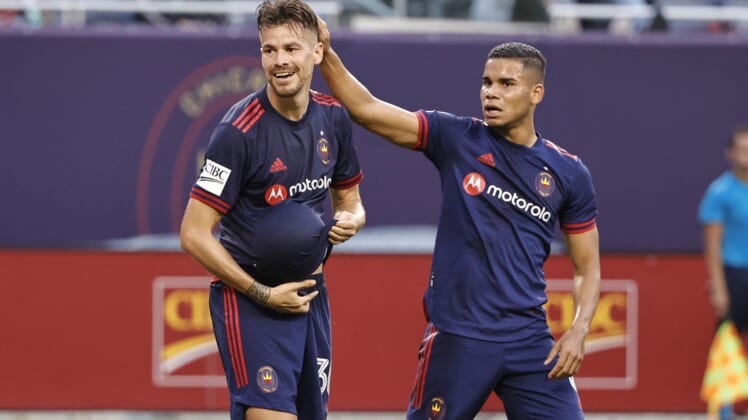 Jul 21, 2021; Chicago, Illinois, USA; Chicago Fire midfielder Gaston Gimenez (30) celebrates with defender Miguel Angel Navarro (6) after scoring against D.C. United during the first half of MLS game at Soldier Field. Mandatory Credit: Kamil Krzaczynski-USA TODAY Sports