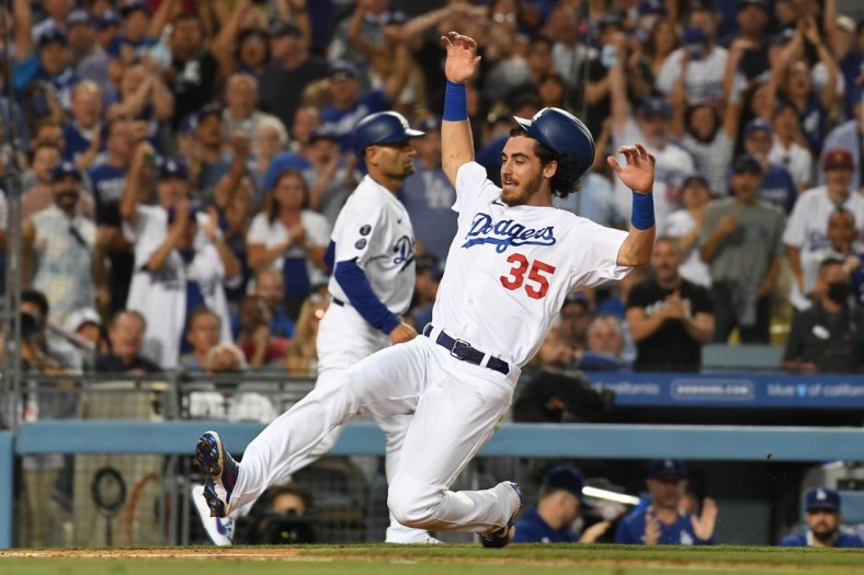 Jul 21, 2021; Los Angeles, California, USA;  Los Angeles Dodgers center fielder Cody Bellinger (35) runs home to score on a double hit by left fielder AJ Pollock (not pictured) in the fourth inning against the San Francisco Giants at Dodger Stadium. Mandatory Credit: Richard Mackson-USA TODAY Sports