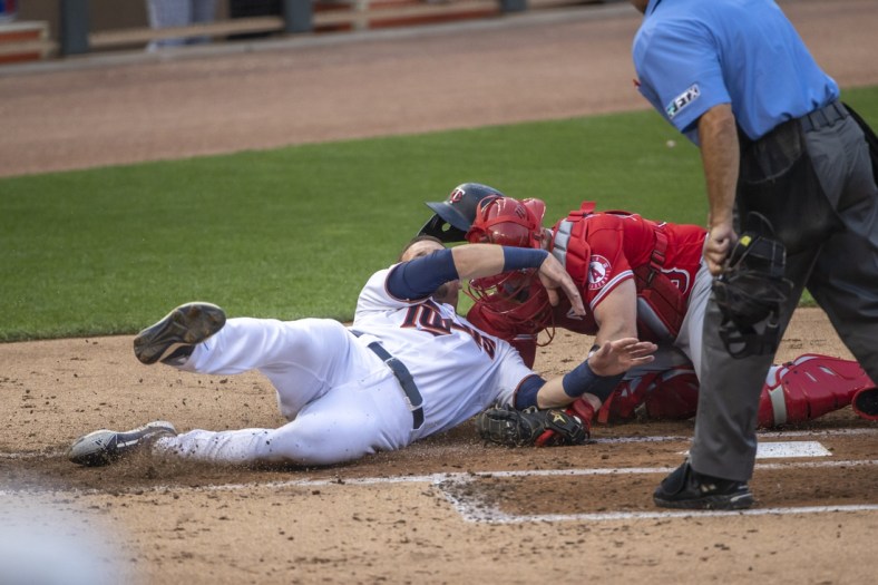 Jul 22, 2021; Minneapolis, Minnesota, USA; Minnesota Twins left fielder Trevor Larnach (24) gets tagged out at home plate from Los Angeles Angels catcher Max Stassi (33) in the second inning at Target Field. Mandatory Credit: Jesse Johnson-USA TODAY Sports