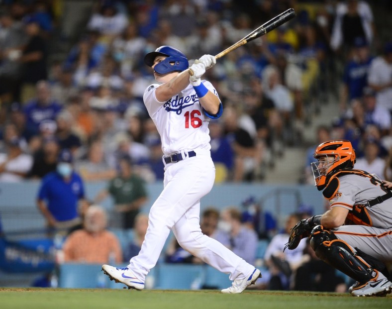 Jul 22, 2021; Los Angeles, California, USA; Los Angeles Dodgers catcher Will Smith (16) hits a two run home run against the San Francisco Giants during the fourth inning at Dodger Stadium. Mandatory Credit: Gary A. Vasquez-USA TODAY Sports