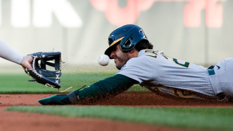 Jul 23, 2021; Seattle, Washington, USA; Oakland Athletics center fielder Ramon Laureano (22) is caught trying to steal second base during the second inning at T-Mobile Park. Mandatory Credit: Jennifer Buchanan-USA TODAY Sports