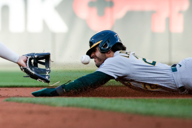 Jul 23, 2021; Seattle, Washington, USA; Oakland Athletics center fielder Ramon Laureano (22) is caught trying to steal second base during the second inning at T-Mobile Park. Mandatory Credit: Jennifer Buchanan-USA TODAY Sports