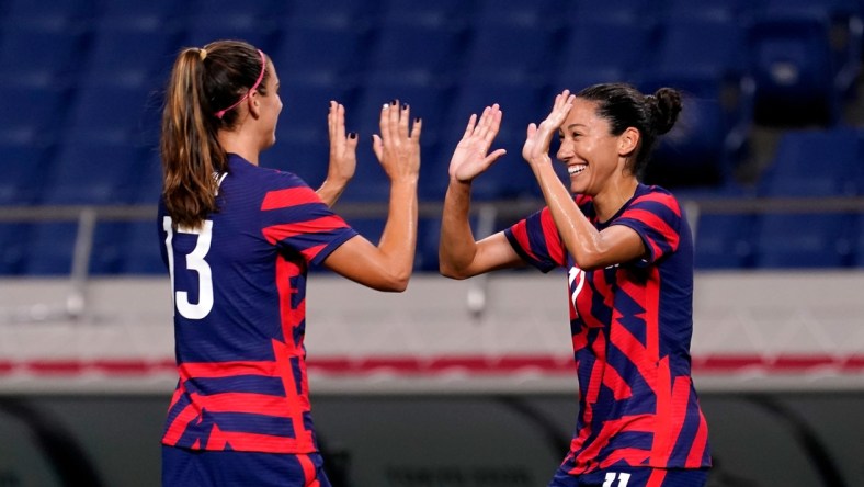 Jul 24, 2021; Saitama, Japan; United States forward Christen Press (11) celebrates her goal against New Zealand with forward Alex Morgan (13) during the second half in group G play during the Tokyo 2020 Olympic Summer Games at Saitama Stadium. Mandatory Credit: Jack Gruber-USA TODAY Network