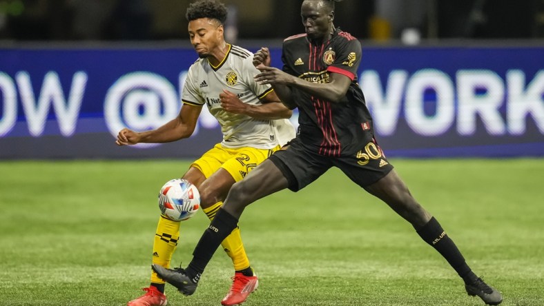 Jul 24, 2021; Atlanta, Georgia, USA; Columbus Crew defender Saad Abdul-Salaam (26) and Atlanta United forward Machop Chol (30) battle for control of the ball during the first half at Mercedes-Benz Stadium. Mandatory Credit: Dale Zanine-USA TODAY Sports