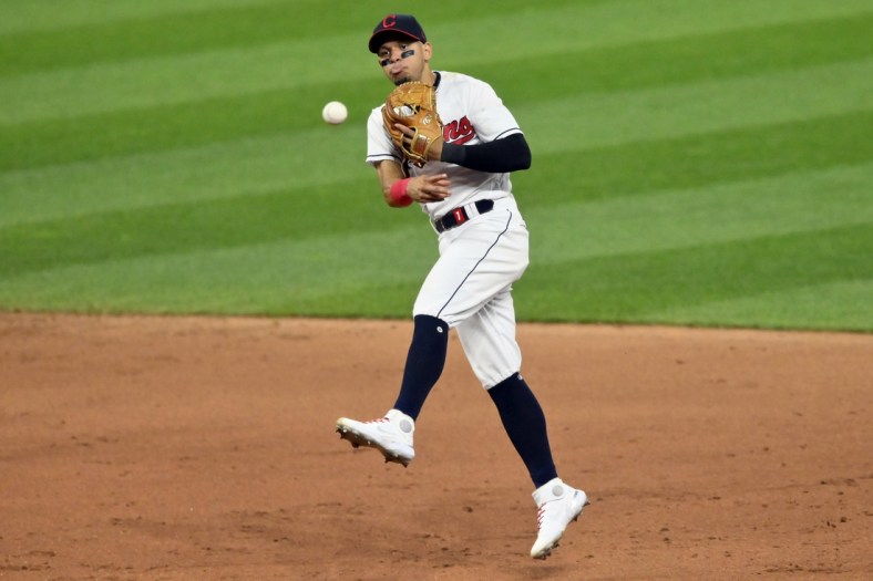 Jul 24, 2021; Cleveland, Ohio, USA; Cleveland Indians second baseman Cesar Hernandez (7) throws to first base against the Tampa Bay Rays in the eighth inning at Progressive Field. Mandatory Credit: David Richard-USA TODAY Sports