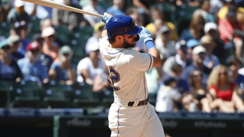 Jul 25, 2021; Seattle, Washington, USA; Seattle Mariners designated hitter Luis Torrens (22) hits an RBI single against the Oakland Athletics during the third inning at T-Mobile Park. Mandatory Credit: Joe Nicholson-USA TODAY Sports